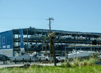 What Should You Do First After Your Commercial Property Is Damaged by a Hurricane? a boat yard with boats and a large building