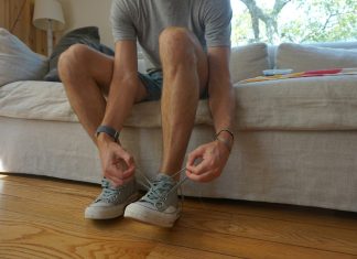 The Secret to Healthy Legs Many in Brooklyn Don’t Know About a man sitting on a couch holding his shoes
