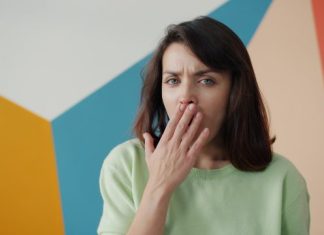 Key Signs You Need General Dentistry Services For Long-Term Relief Woman covering mouth with hand, looking surprised.