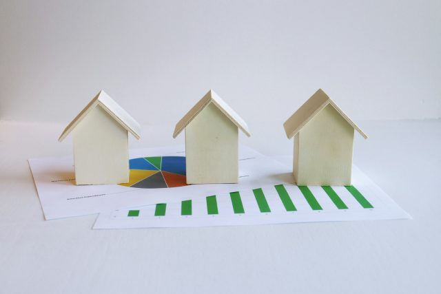 Photo by Artful Homes three small houses sitting on top of a piece of paper