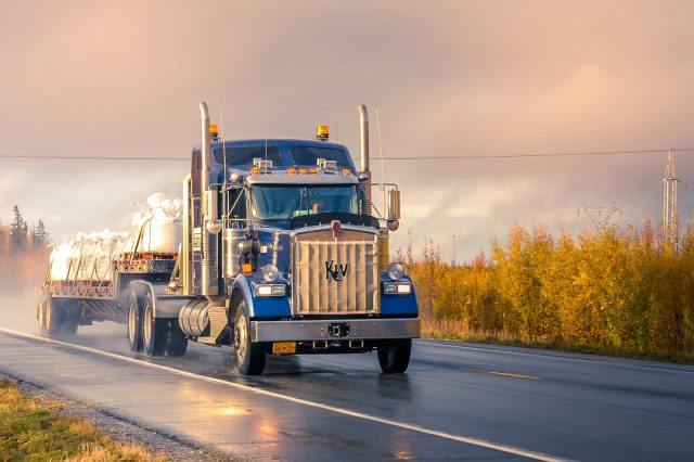 Photo by Zetong Li white and blue truck on road during daytime