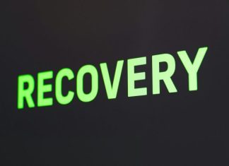 Key Benefits of Seeking Professional Addiction Treatment Over Self-Help a close up of a sign that reads recovery
