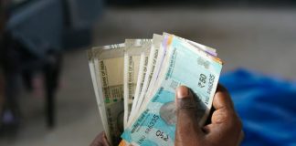 A person holding a bunch of money in their hand