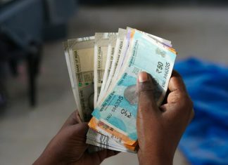 A person holding a bunch of money in their hand