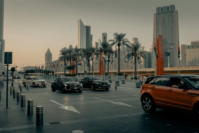Photo by Clay Banks cars on road near buildings during daytime