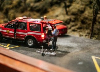 How to Deal with Insurance After Being Injured in an Accident a miniature scene of a red car with a man standing next to it