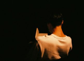 How Books On Porn Addiction Help People Reclaim Daily Balance a person standing in the dark with their back to the camera