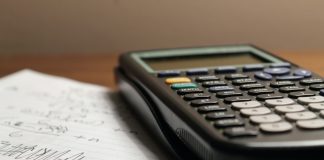 a calculator sitting on top of a piece of paper