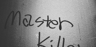 a black and white photo of a wall with writing on it