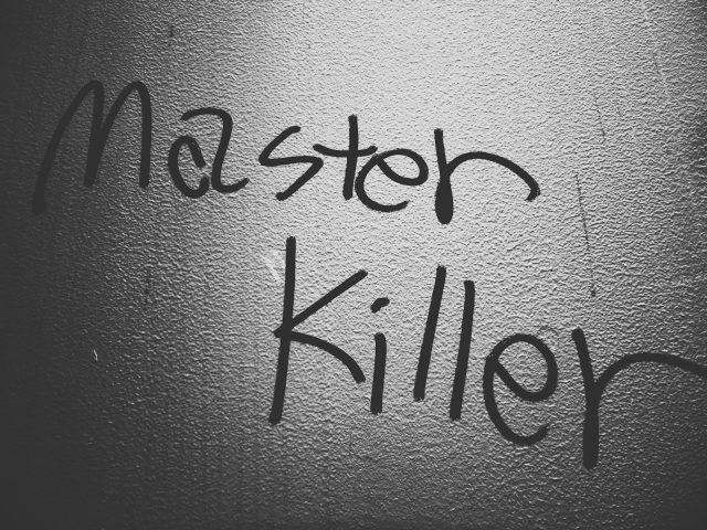 a black and white photo of a wall with writing on it