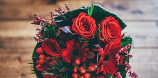 red flower bouquet on brown surface