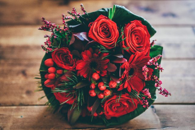 Photo by Nick Karvounis red flower bouquet on brown surface