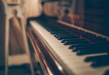 Discovering Music’s Hidden Potential Through Flexible Piano Rental Options a close up of a piano with a person in the background