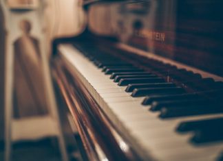 Discovering Music’s Hidden Potential Through Flexible Piano Rental Options a close up of a piano with a person in the background