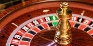 A roulette wheel with a gold ball on top AI-generated content may be incorrect.