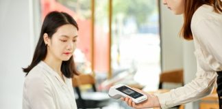 woman in white long sleeve shirt holding white smartphone