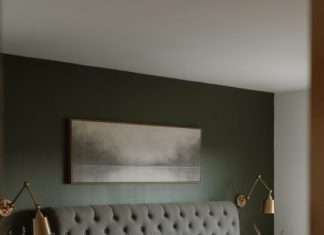 The Hidden Superpowers of Headboards: Storage, Soundproofing, Statement Design A modern bedroom with a tufted headboard and art.
