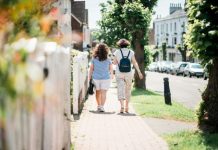 Why Reconnecting Can Change Everything two women walking down sidewalk near fence