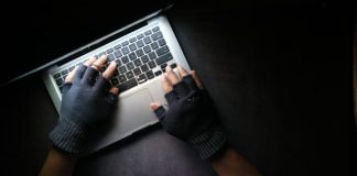 person in black long sleeve shirt using macbook pro