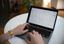 How business clouds are becoming workflow engines Hands typing on a laptop with a spreadsheet on screen.