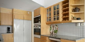 A kitchen with wooden cabinets and white appliances