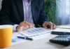 How a managed SIEM system can offer the best defence against cyberattacks and hacking person in black suit jacket holding white tablet computer