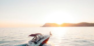 man riding on white and red boat on sea during daytime