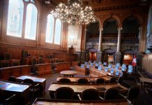 From Pavement to Courtroom: The Hidden Process Toward Accountability a large room with chairs and a chandelier