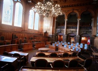 From Pavement to Courtroom: The Hidden Process Toward Accountability a large room with chairs and a chandelier