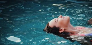 woman floating on body of water