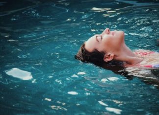 How to Relax Your Body After an Exhausting Week woman floating on body of water