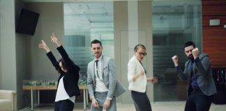 Business people celebrating and dancing in office