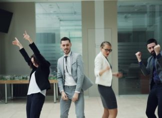 Business people celebrating and dancing in office
