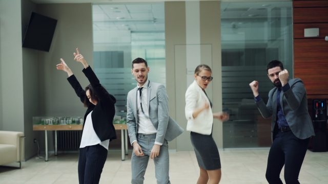 Photo by Vitaly Gariev Business people celebrating and dancing in office