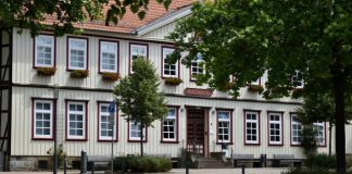 Traditional timber-framed building with white windows.