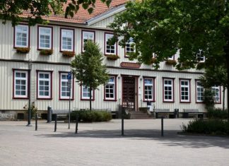 Traditional timber-framed building with white windows.
