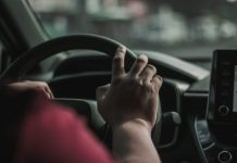 What to Do After a Car Accident in the San Fernando Valley a person driving a car with their hand on the steering wheel