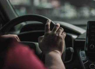 What to Do After a Car Accident in the San Fernando Valley a person driving a car with their hand on the steering wheel