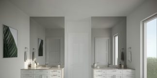 a large bathroom with two sinks and two mirrors