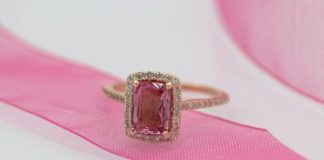 gold and silver ring on pink textile