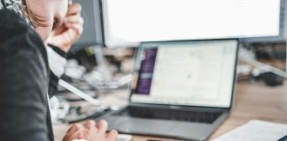 black iPhone near MacBook Pro