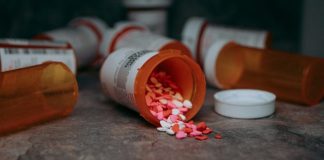 a close up of a bottle of pills on a table