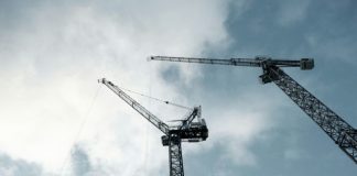 black crane under cloudy sky during daytime