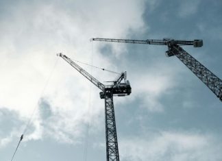 black crane under cloudy sky during daytime