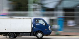 blue and white van on road during daytime