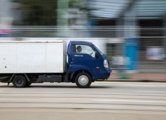 What Are The Leading Causes of Commercial Truck Accidents in Texas? blue and white van on road during daytime