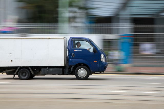 Photo by Arron Choi blue and white van on road during daytime
