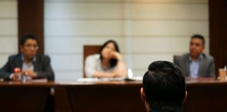man in black shirt sitting beside woman in white shirt