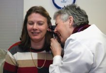 a woman talking on a cell phone next to a man