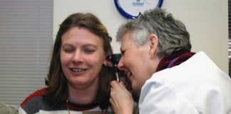 a woman talking on a cell phone next to a man